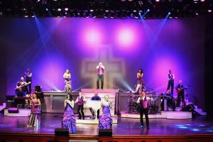 a group of performers on a stage with purple lights at 2 King BRs Balcony Resort Amenities Free Tix in Pigeon Forge +26 photos