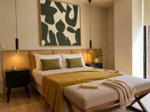 a bedroom with a large bed and a painting at DreamHaus Suites - Country Club Guadalajara in Guadalajara +152 photos