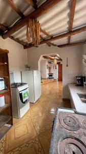 a kitchen with a stove and a refrigerator at La Gruta Glamping in Fúquene