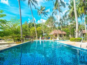 a swimming pool at a resort with palm trees at Am Samui Resort Taling Ngam in Taling Ngam Beach