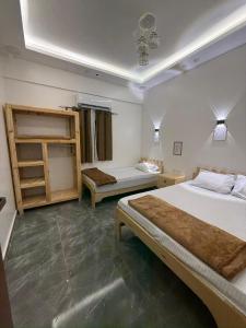 a bedroom with two beds in a room with a ceiling at Villa Solla Dahab in Dahab