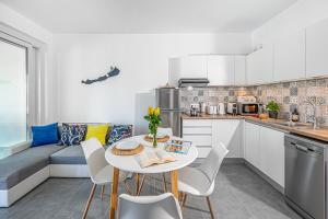 a kitchen with a table and chairs in a room at Apartman 360 in Balatonalmádi