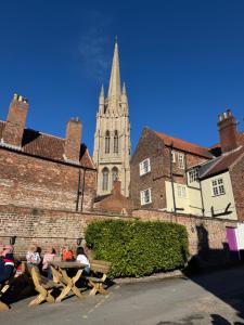 a group of people sitting on a bench in front of a church at Rooftops in Louth