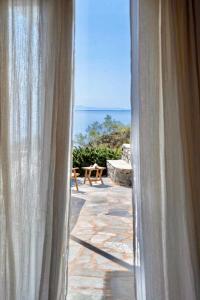 a view of the ocean from a window at Demetra Waterfront House-Authentic Syros, by Elefthia Syros in Megas Gialos - Nites