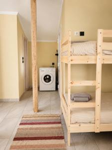 a room with bunk beds and a washing machine at Ouranoupolis View Point in Ouranoupoli