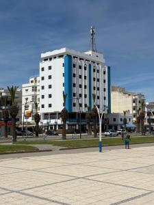 a large white and blue building in a city at Étoile in M'diq