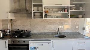 a kitchen with a sink and a stove and cabinets at Peribacası Manzaralı Modern Daire 2 in Ürgüp +14 photos
