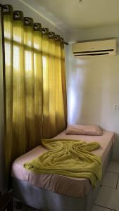 a bed with a blanket on it in a room at HOTEL REAL in Marechal Cândido Rondon +3 photos