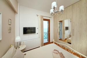 a bedroom with a mirror and a bed and a sink at Aeraki Home in Skopelos Town