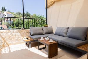 a living room with a couch and a table at Stone house Sprtini-Brač in Ložišće