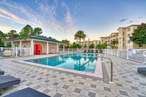 a swimming pool with a white fence and a building at St James Bay Golf & Pickleball Resort in Big Blackjack Landing