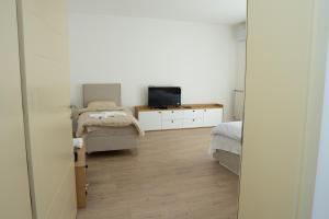 a bedroom with a bed and a tv and a mirror at Hotel Han Gusinje in Gusinje
