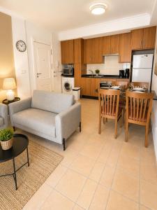 a living room with a couch and a kitchen at Casa Azul, with a shared pool in Baños y Mendigo