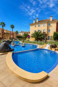 a large swimming pool in front of a building at Casa Azul, with a shared pool in Baños y Mendigo +10 photos