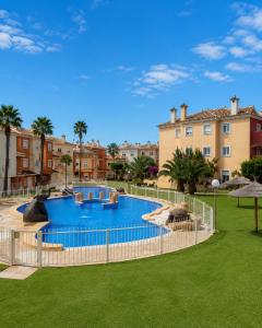a large swimming pool in a yard with buildings at Casa Azul, with a shared pool in Baños y Mendigo