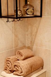 a towel sitting on a shelf in a bathroom at La Charme Du Marais in Paris