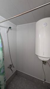a shower in a bathroom with a water tank at Guesthouse Marshan in Ushguli +98 photos