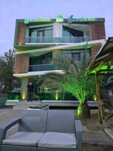 a person standing in front of a building at Green House in Ureki