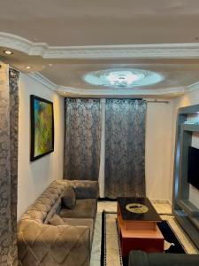 a living room with a couch and a television at RÉSIDENCE IDM-Ngoma in Kinshasa
