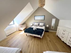 a large bedroom with a bed and a attic at Villa les dunes in Carantec +61 photos