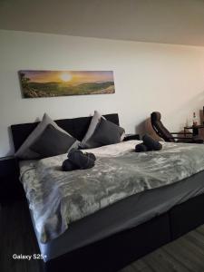 a bed with pillows on it in a room at Ferienwohnung Molly inclusive Hallenbad, Sauna, Fitnessstudio und Aussenpool in Sankt Englmar +21 photos