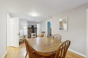 a dining room with a wooden table and chairs at Champ's Camp in Colchester