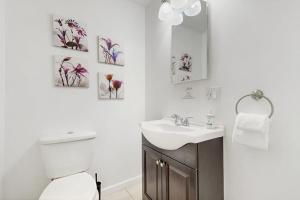 a white bathroom with a sink and a toilet at Champ's Camp in Colchester +41 photos