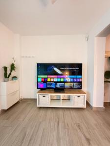 a living room with a flat screen tv on a table at Brisas del mar in Faro de Cullera