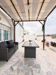 an outdoor patio with a table and chairs at Brisas del mar in Faro de Cullera