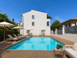 a swimming pool in front of a house at Primo Hotel in Marciana Marina