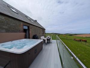a hot tub on the deck of a house at 3 Bed in Girvan oc-96394 in Girvan