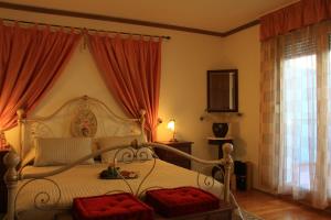 a bedroom with a canopy bed with red curtains at Apartments Znjan in Split