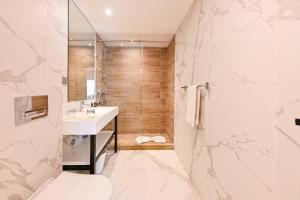 a bathroom with a shower and a toilet and a sink at Aruba Casablanca City Center in Casablanca +22 photos