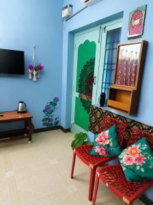 a living room with a couch and a television at BlueWaves in Pondicherry