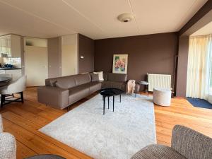 a living room with a couch and a table at Villa Water en Meer in Terherne