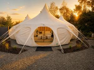 a white tent with a living room in it at Forest Hillside Glamping Retreat in Lochiel