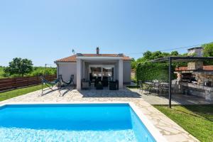 a pool in the backyard of a house at Holiday Home Casa Vida in Rakalj +41 photos