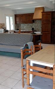 a kitchen with a table and chairs and a couch at Gite 2 des Ecuries du Seillery in La Clisse