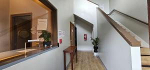 a hallway with a staircase and a display case at Farwest Motel in Everett