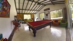 a living room with a pool table in it at Glamping mágico en el Bosque in Oicatá