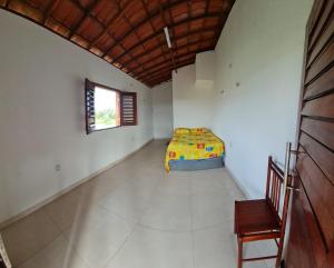 a room with a bed and a chair in it at Casapraiatracuá in Beberibe +28 photos