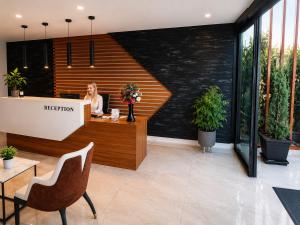 a woman sitting at a reception desk in a lobby at Bodrum Blue Bay Hotel & Restaurant in Bodrum City +31 photos