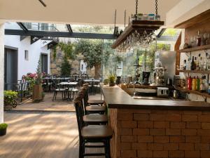a restaurant with a bar with chairs and tables at Bodrum Blue Bay Hotel & Restaurant in Bodrum City