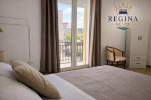 a bedroom with a king sized bed and a window at Regina Suite Mazara in Mazara del Vallo