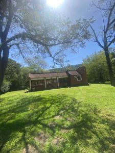 a house on a grassy field with a tree at la casona de yala in Yala +5 photos