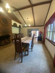 a dining room with a table and chairs and a fireplace at la casona de yala in Yala