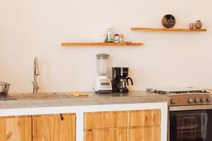 a kitchen with a counter top with a blender at Calma Ometepe in Santa Cruz +10 photos