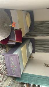 a pile of pillows sitting on top of a bed at Beit Emna3 in Kairouan