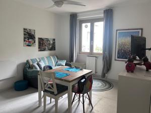 a living room with a table and a couch at Verde Lido in Livorno