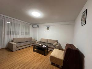 a living room with a couch and a table at Boulevard Mitrovica in Mitrovica